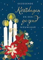 Kaarsen en bloemstuk kerst gezegend